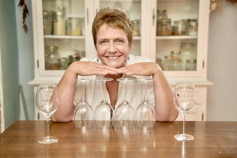 Gaby Guzek in front of empty wine glasses